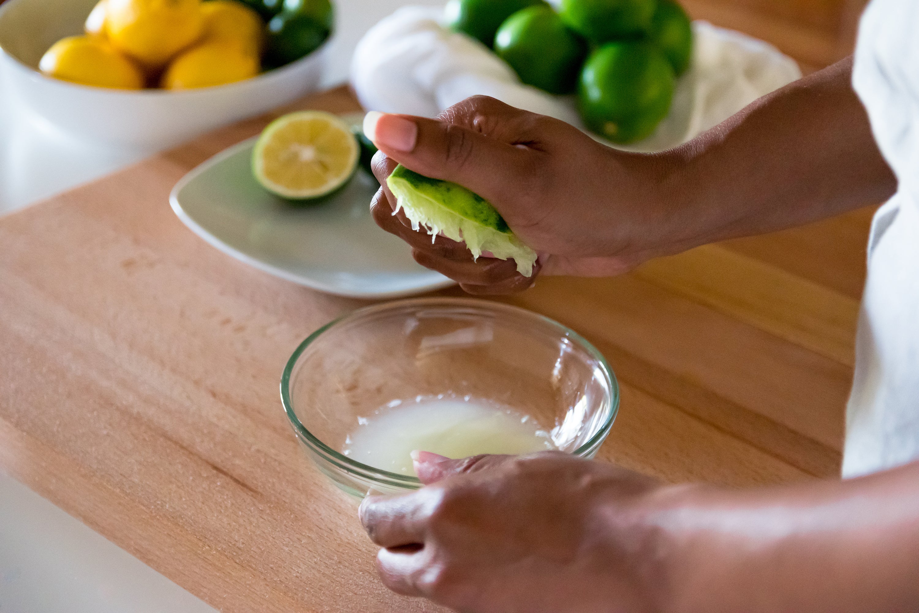 Freshly squeezed limes into a bowl.