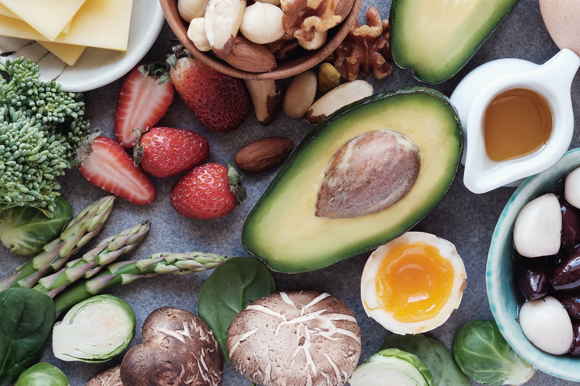 A healthy spread of fruits and vegetables including healthy fats such as avocados.