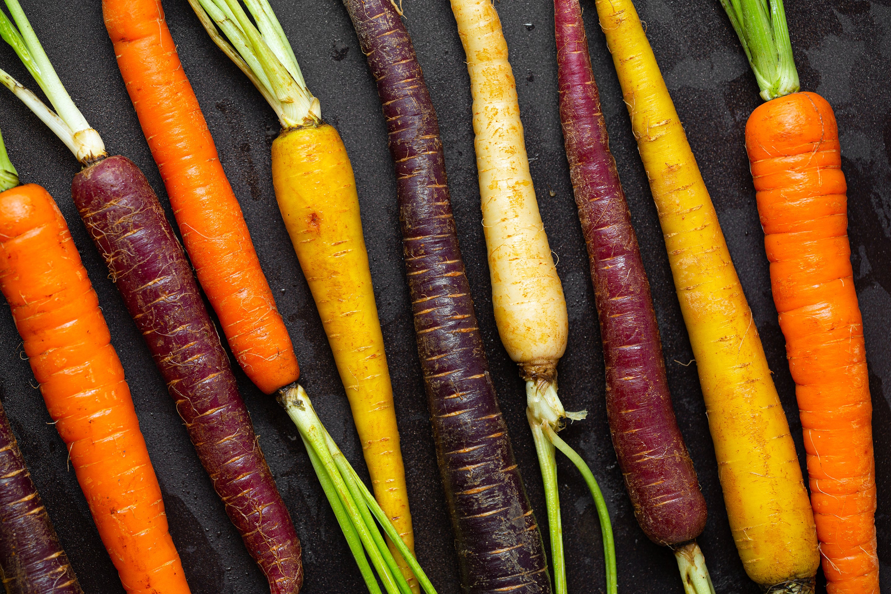 Fresh, colorful carrots used in Kekoa Foods organic baby food pouches.