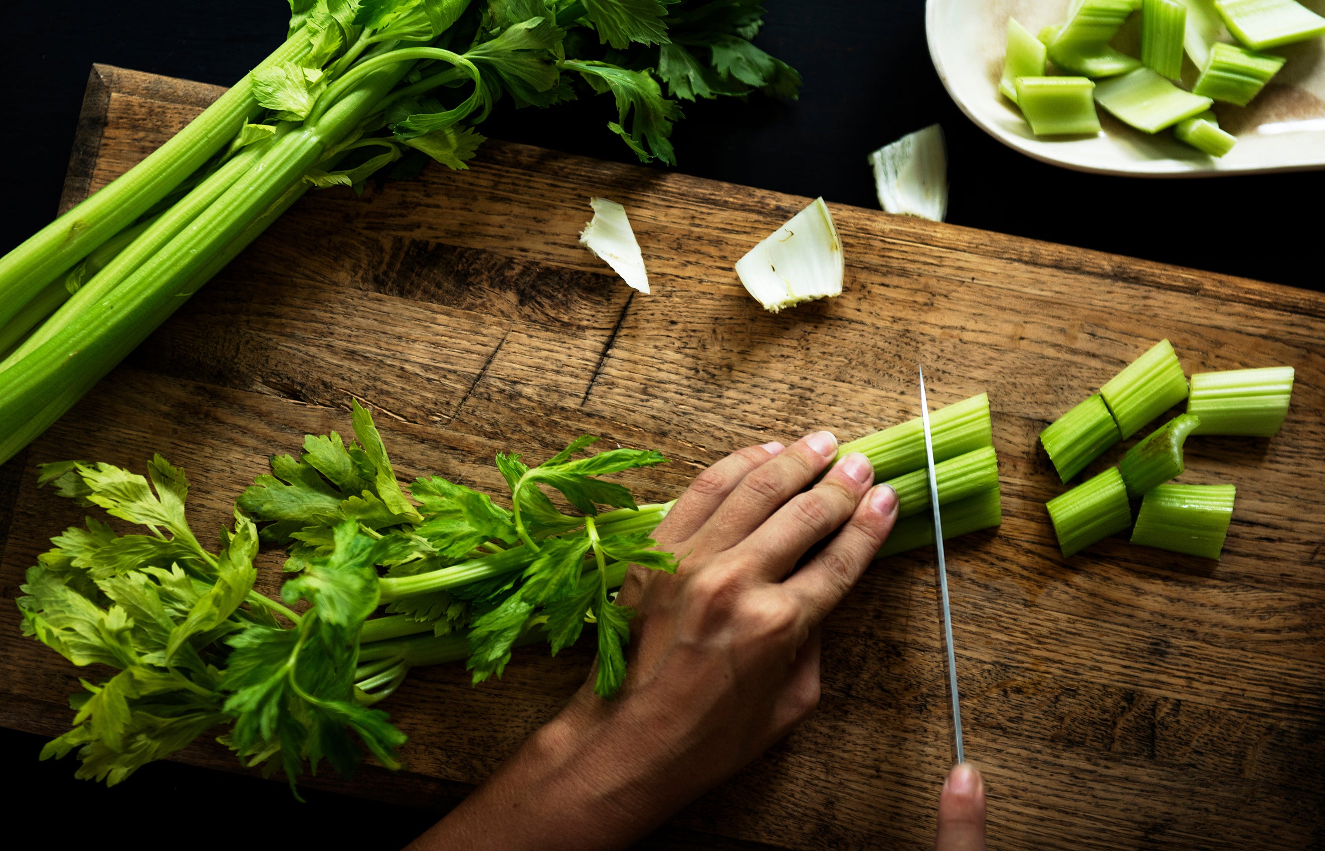 Chopping up fresh celery used in Kekoa Foods baby food pouches.