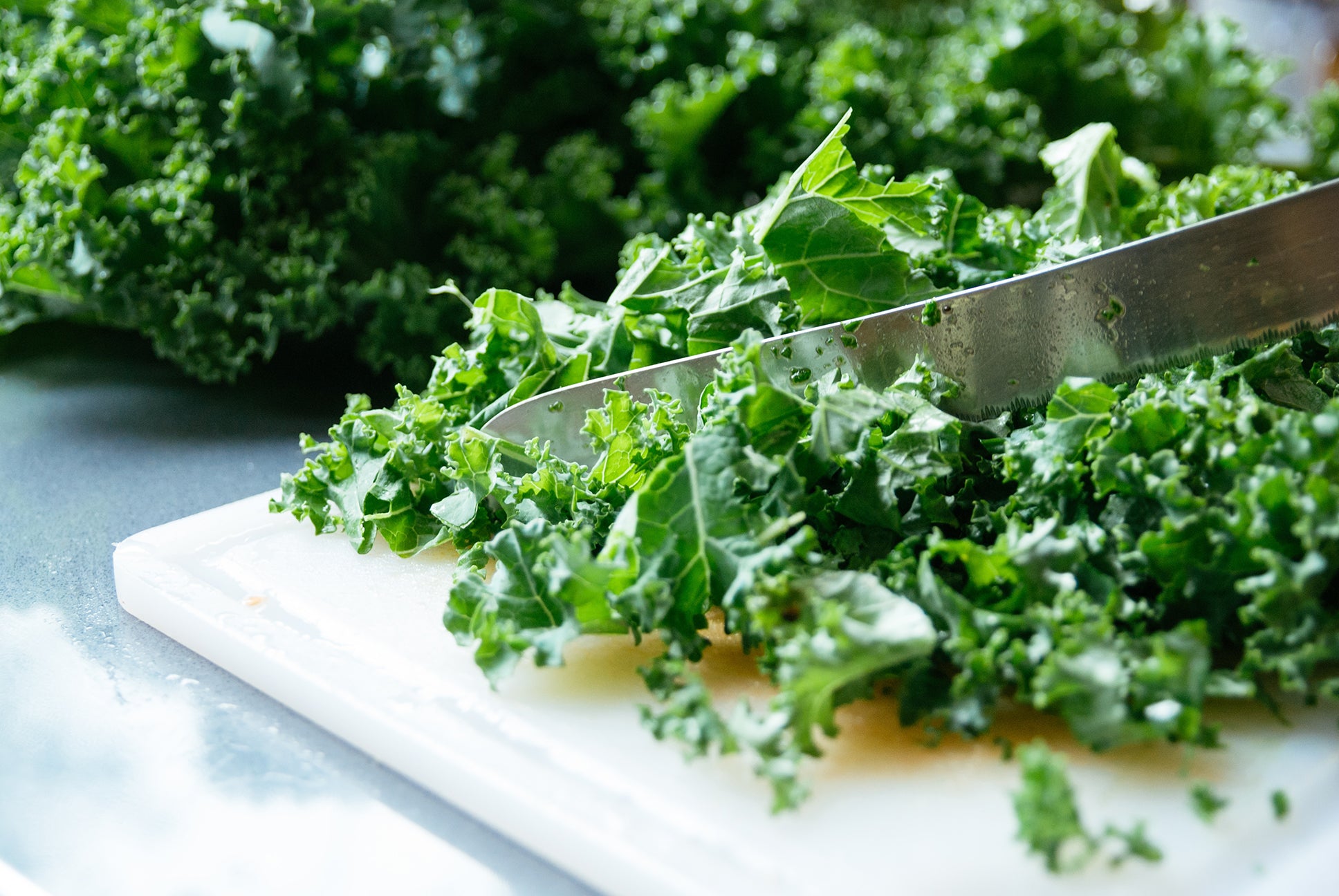 Cutting up fresh kale used in Kekoa Foods organic baby food.