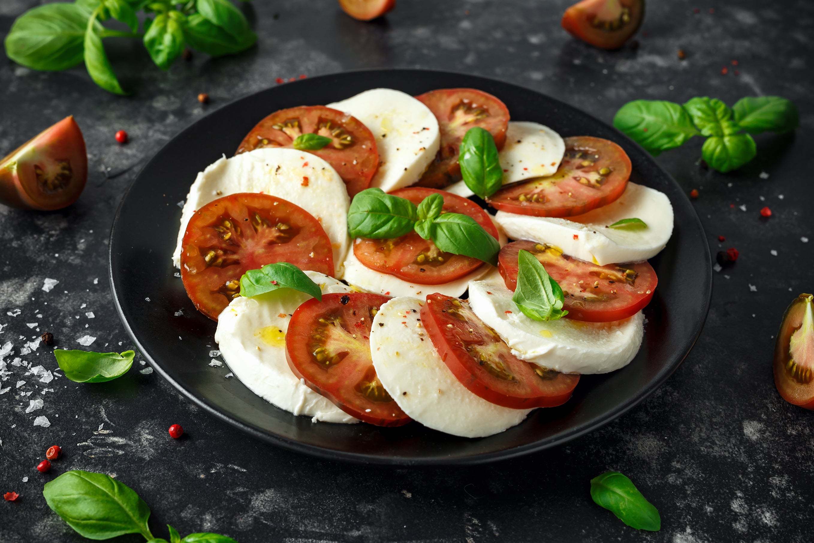 Caprese Salad is a classic Italian salad made with fresh mozzarella, sliced tomatoes, and basil leaves. 
