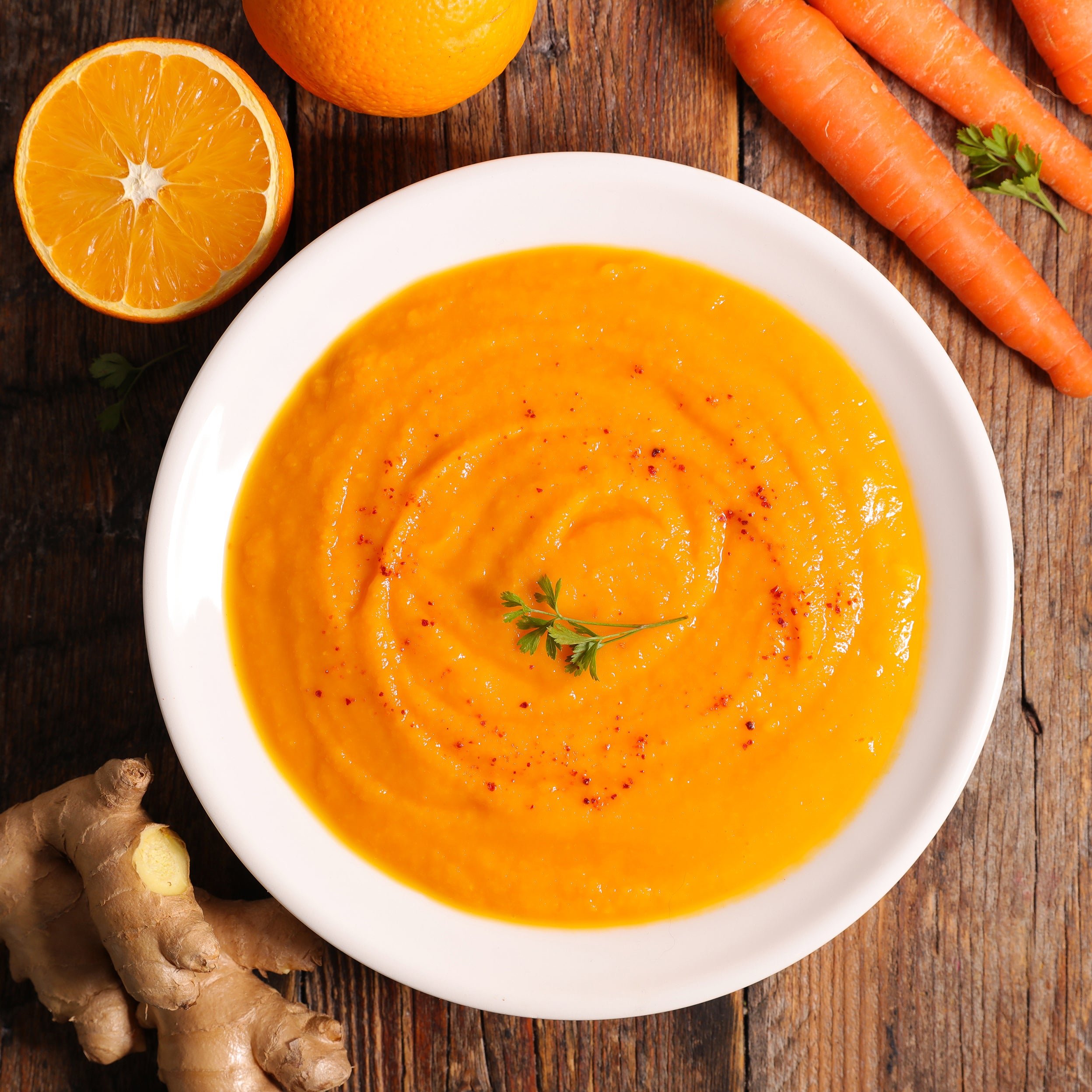 Carrot soup is a creamy soup made with pureed carrots, onions, and chicken or vegetable broth.