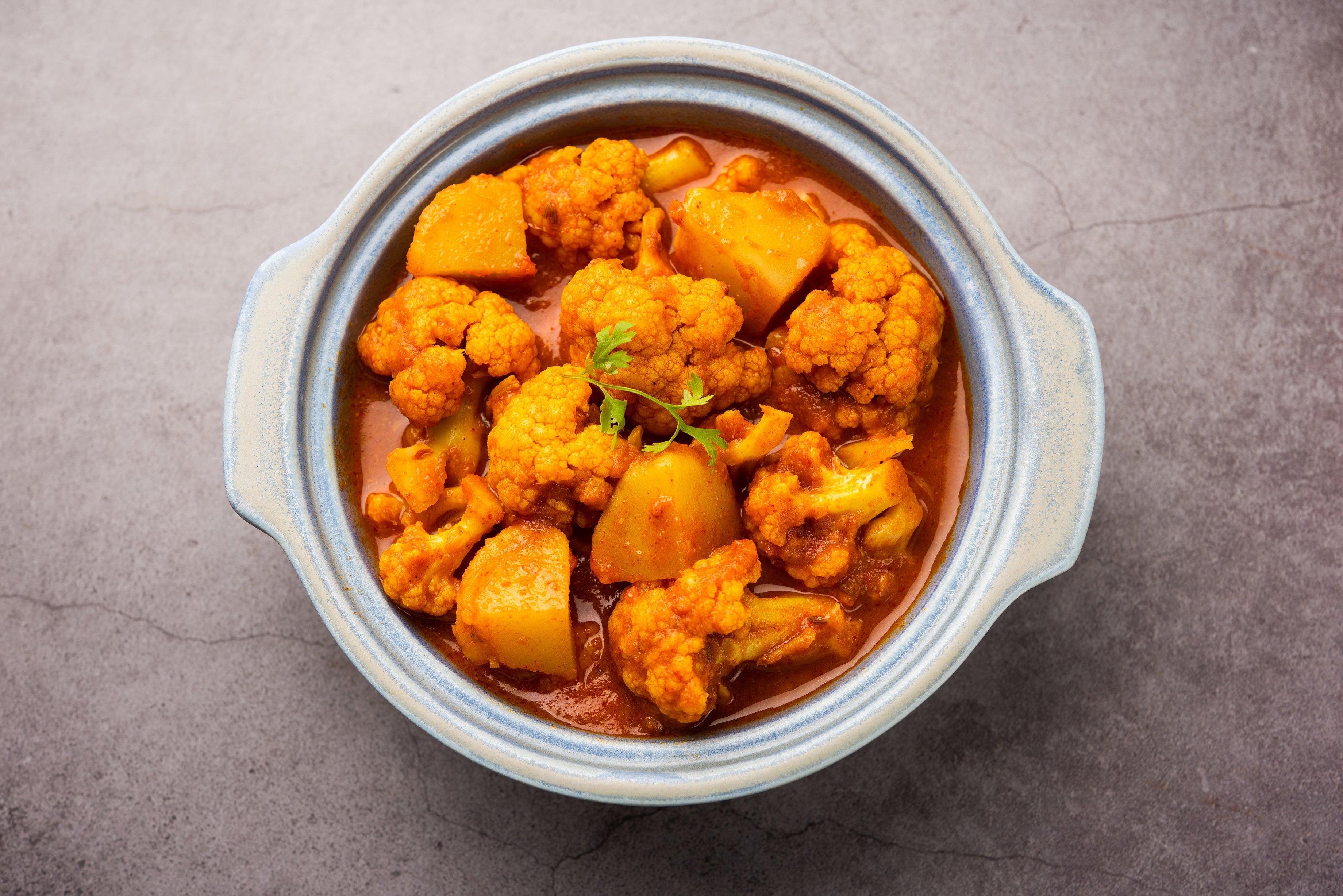 Aloo Gobi*A classic Indian dish made with cauliflower and potatoes, flavored with spices such as cumin, turmeric, and coriander.