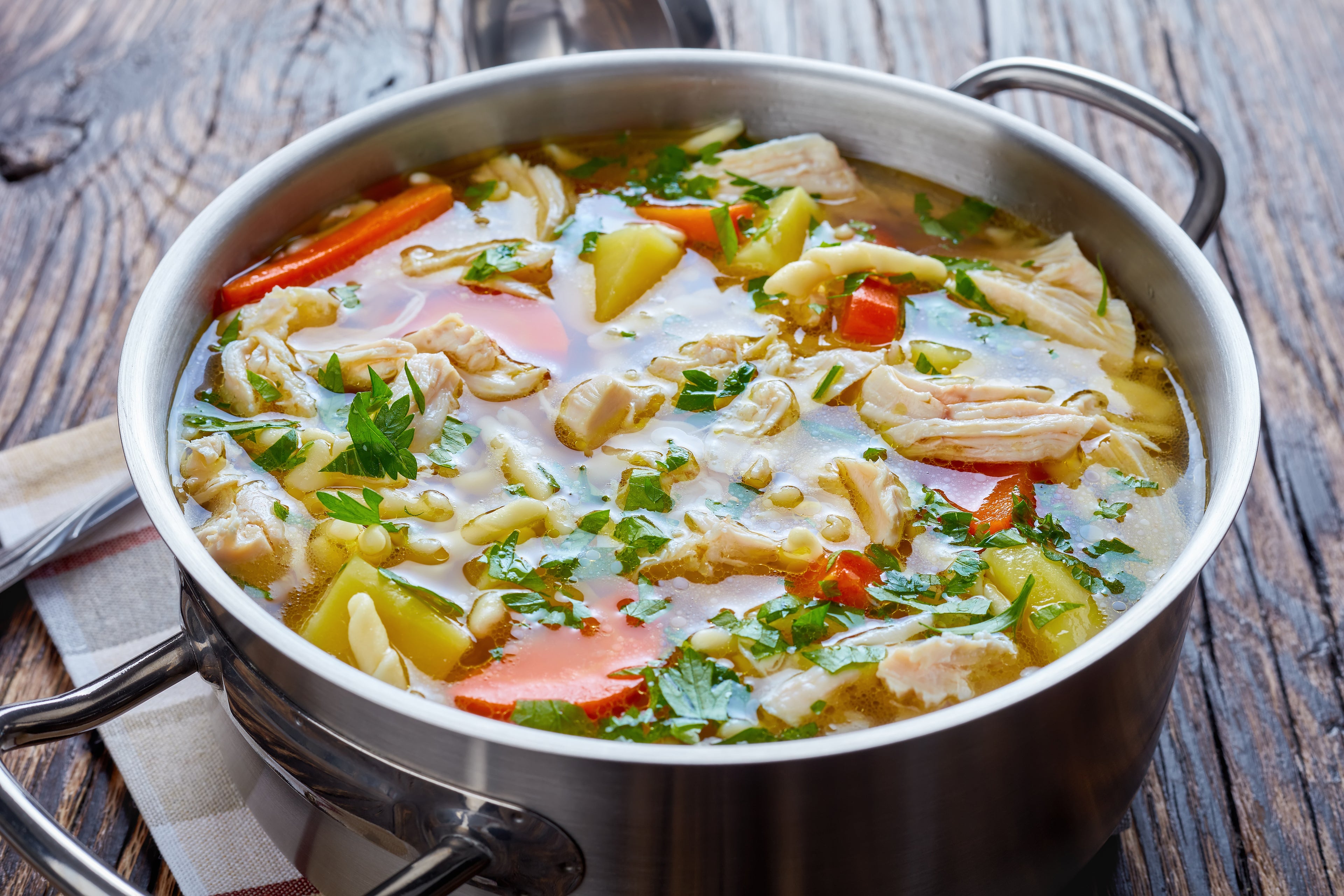 Chicken Soup is a comforting soup made with chicken broth, diced celery, carrots, and noodles or rice.