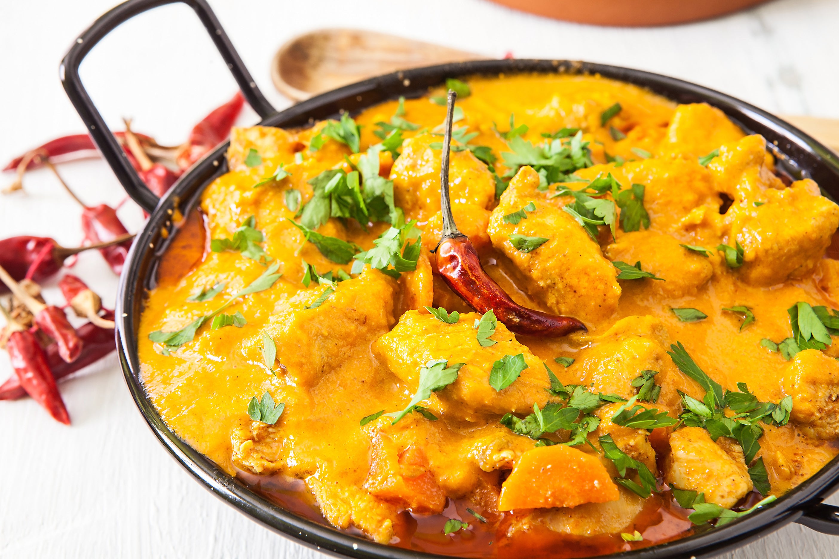 Indian Curry is a spicy and flavorful dish made with meat or vegetables, and a blend of spices such as coriander, cumin, and turmeric.