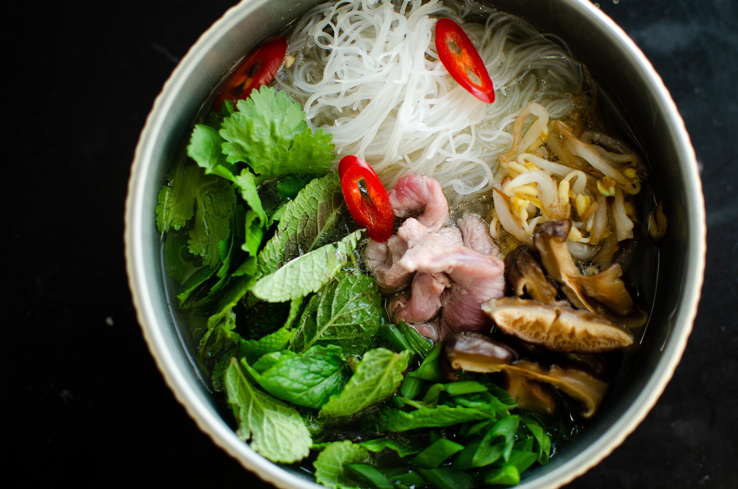Vietnamese Pho is a fragrant and flavorful noodle soup made with beef or chicken broth, rice noodles, herbs, and spices, including star anise.
