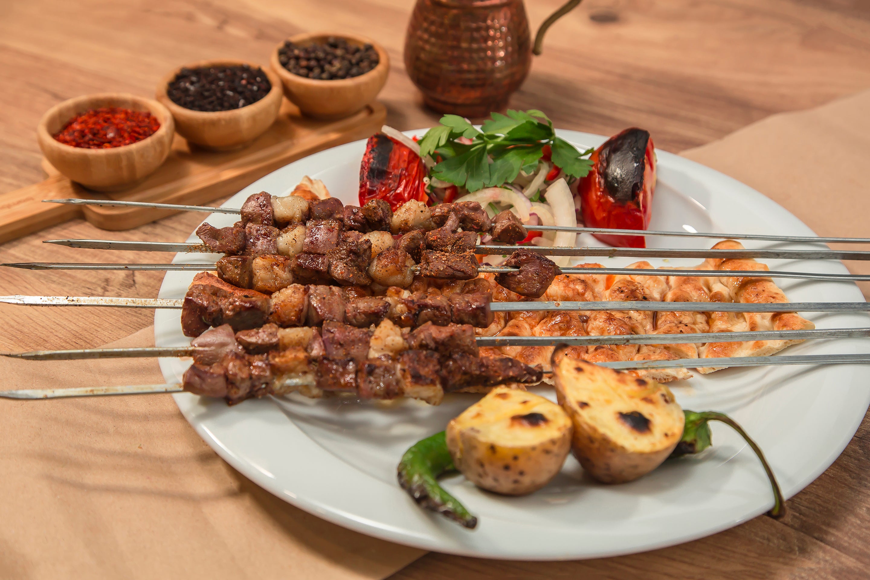 Grilled Chicken Kebabs are skewered chicken pieces marinated in yogurt and spices, including sumac, and then grilled until tender and charred.
